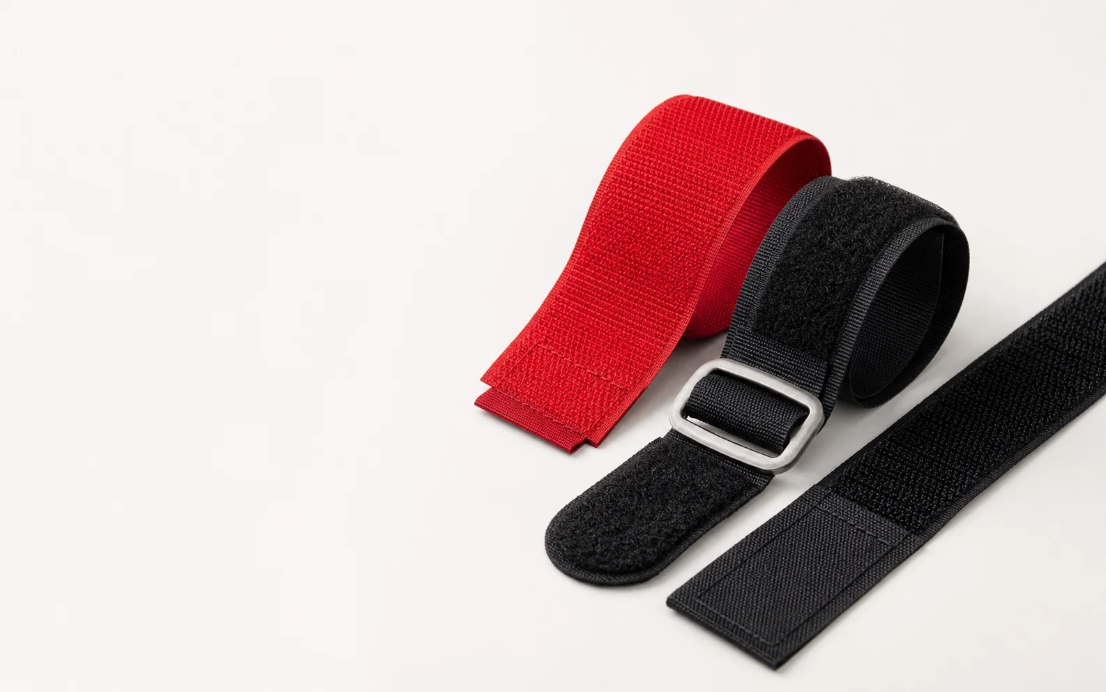 Red and black industrial hook and loop strap products